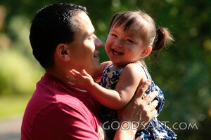 Little girl kissing her daddy.