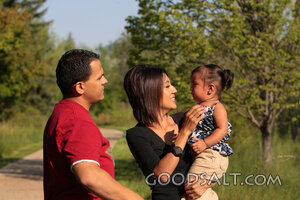 Man and woman comforting crying little girl outdoors