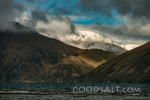 Storm Clouds Over Snowcapped Mountains