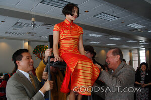 IDAHO. Boise. Asian Jewish girl lifted by her father and gra