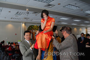IDAHO. Boise. Asian Jewish girl lifted by her father and gra