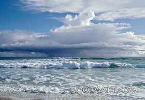 seascape with frothy waves and puffy clouds