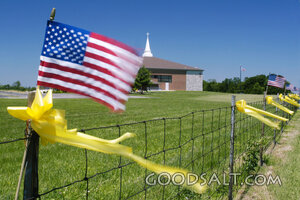 Church Fence with American Flags and Yellow Ribbons