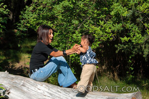 Woman and little girl playing in park.