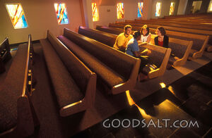 A group of people talking in a church.