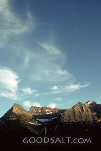 wispy clouds over rocky peaks