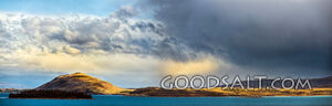 Distinctive yellow and grey cloud hangs over island.