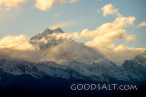 early morning sky over huge snow-clad peak