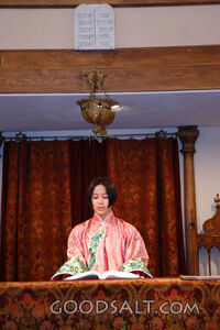IDAHO. Boise. Asian Jewish girl standing at bimah in synagog