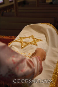 IDAHO. Boise. Hands placing cover over Torah at bimah in syn