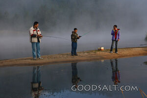 IDAHO. Smith’s Ferry. Man and kids fishing on foggy morning.