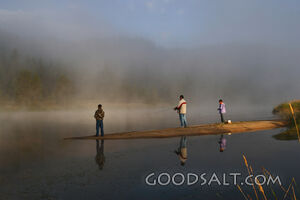 IDAHO. Smith’s Ferry. Man and kids fishing on foggy morning.