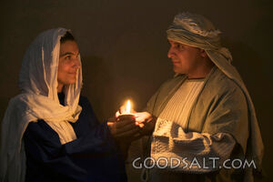 Isrealite Man and Woman Hold Lit Oil Lamp in the Dark