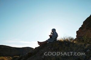 Isrealite Man Sits on Side of Mountain  in Silhouette