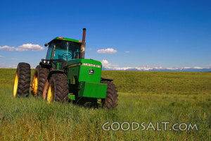 John Deere 4955 farm tractor with Teton mountain range behin