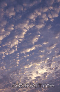 Many light clouds in a dark sky.