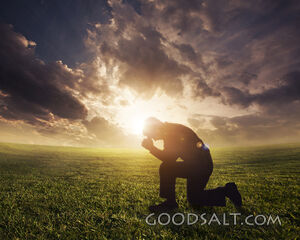 Man Praying at Sunset