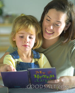 A mother reading with her daughter.