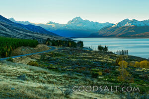 Mountains behind lake waters.