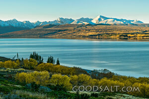 Mountains behind lake waters.