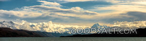 Prominent mountain range behind lake waters.