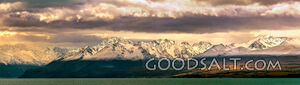 Prominent mountain range behind lake waters.