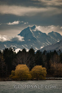 Prominent mountain range behind lake waters.