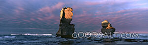 Rock Formations in the Ocean With Pink Clouds