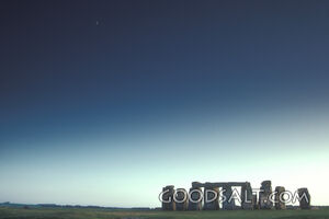 A picture of Stonehenge below a dark sky.