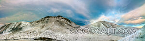 Snow covered mountain range and dramatic cloud effects.