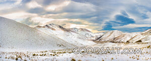 Snow covered mountain range and dramatic cloud effects.