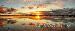 Spectacular sunset and reflection on surface of shallow lake.