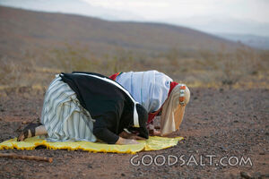 Two Men Kneeling to Pray on Rug